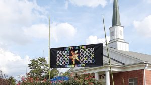 A flag in front of Haven UMC reading, "Unity in the Community"