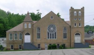Haven UMC, a yellow brick building with stained glass windows and a rose window