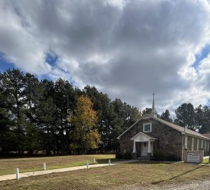 The outside of Hays Chapel, a stone building with a long, cement front walkway