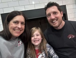 Photo of two adults and a child