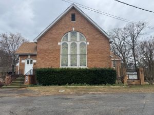 Lockesburg UMC, a red brick building with stained glass windows