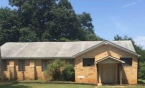 Mt. Carmel UMC, a yellow brick building surrounded by trees