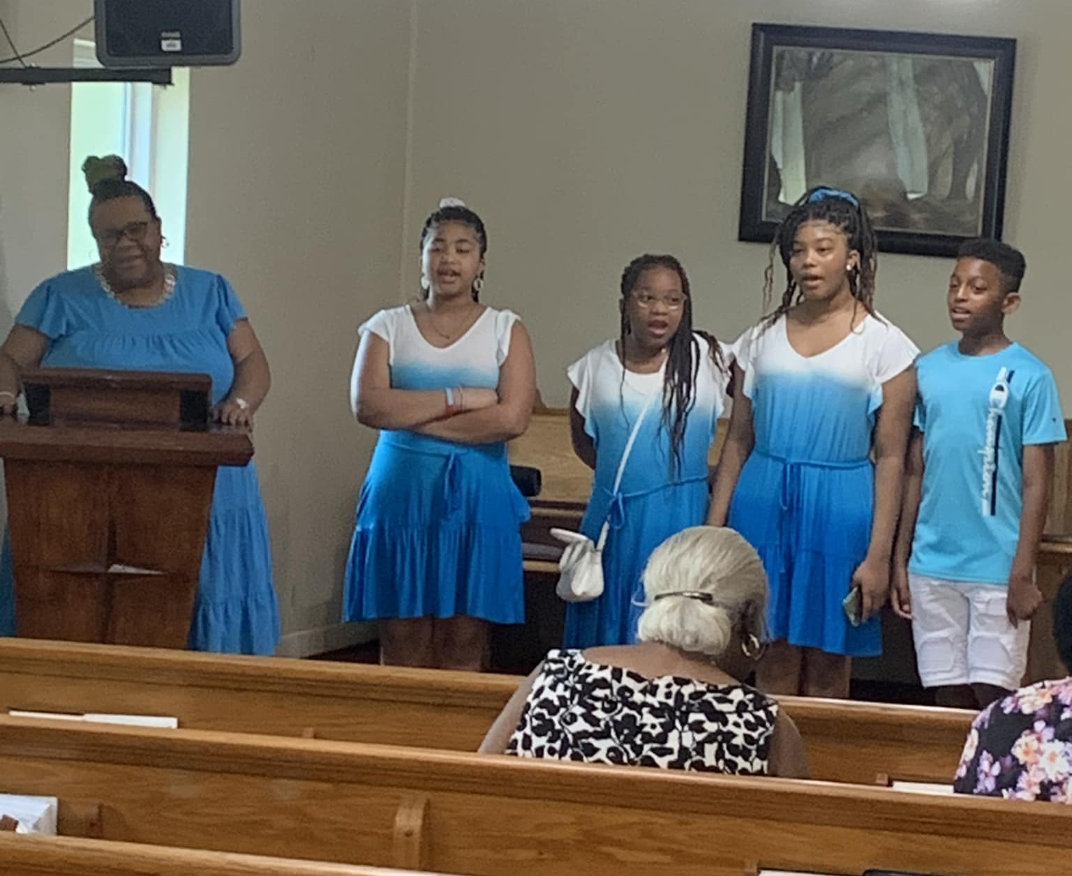 Youth choir dressed in white and blue at New Zion UMC