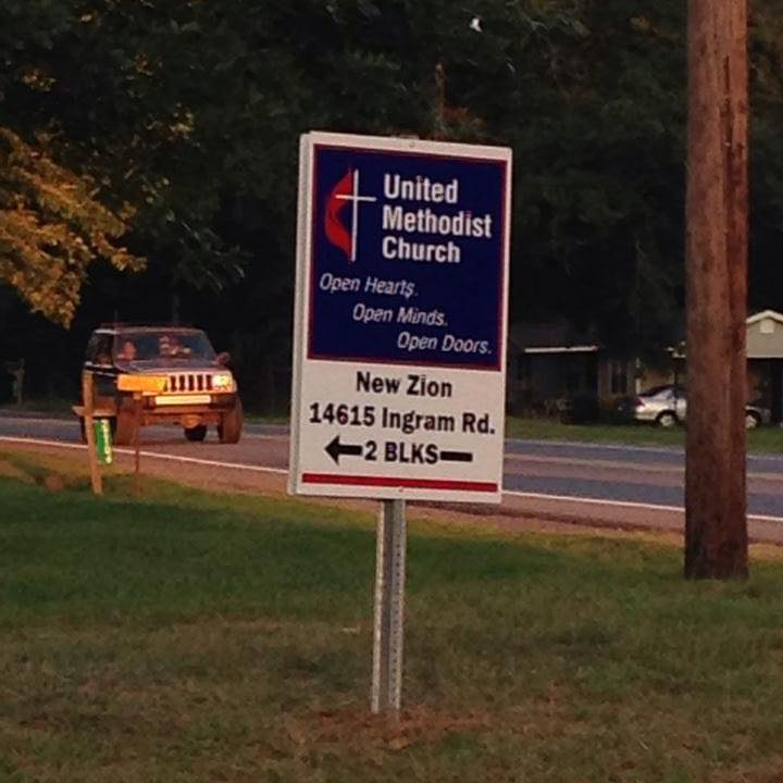 Lawn sign pointing the way to New Zion United Methodist Church