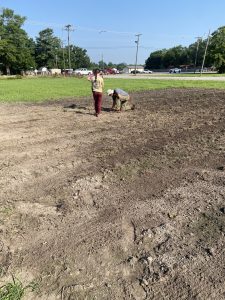 Checking seed depth and seeing the results of the planter Dr. Gill Giese works with the Newport High School students
