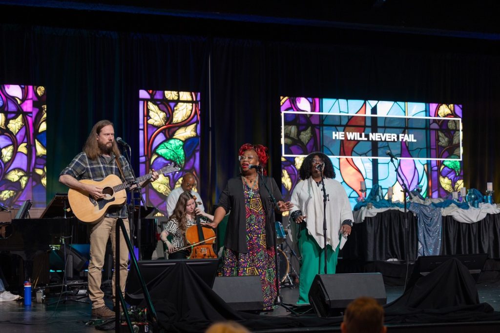A group of five musicians performing on stage